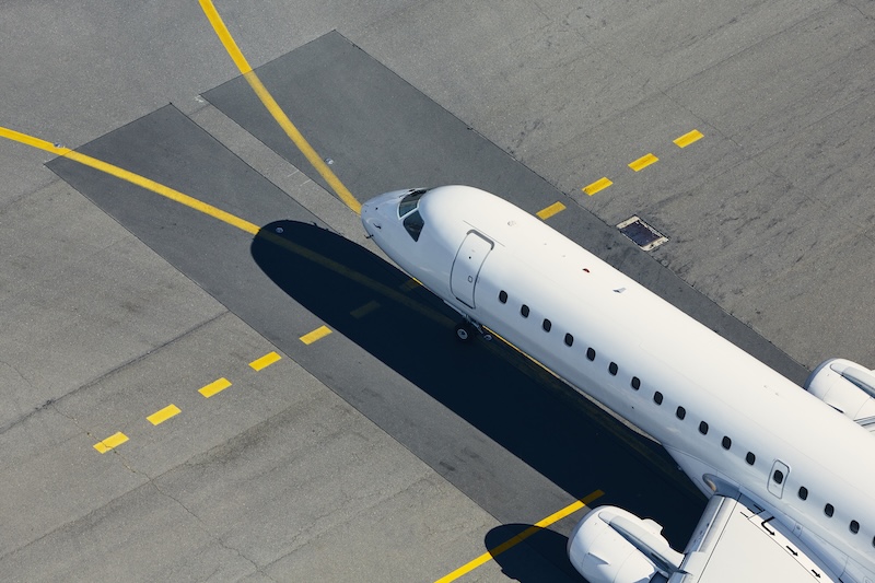 Aerial view of an aircraft on airport pavement