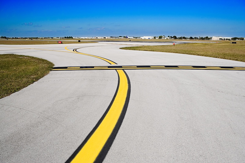 Airport taxiway with yellow centerline